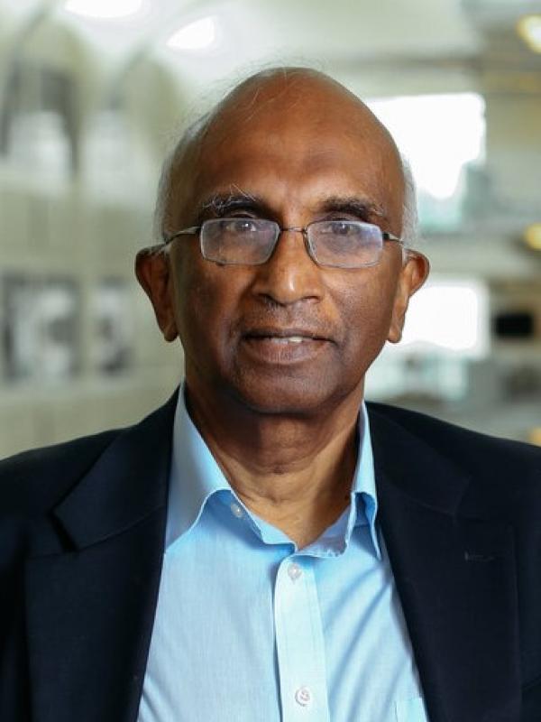 Headshot of Professor Sooryakumar with blurry PRB Atrium in the background