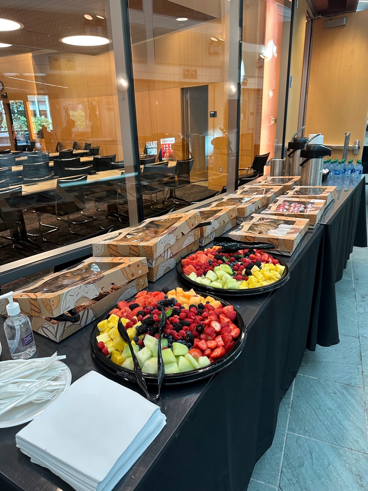 Fruit trays and donuts on table just outside Smith Seminar Room