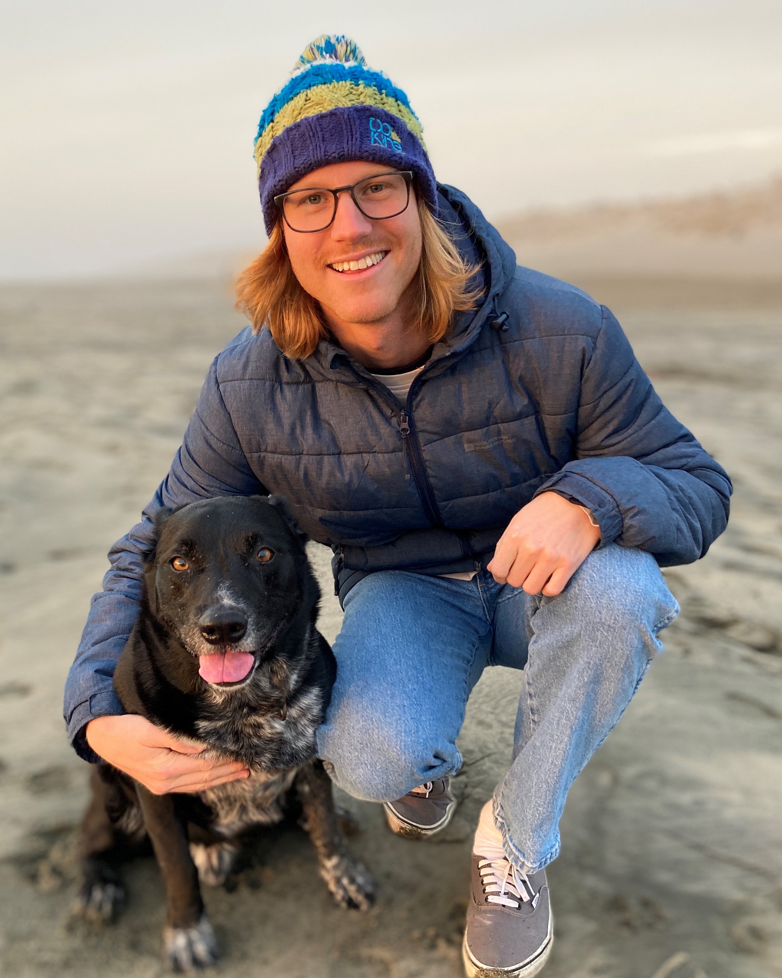 Photo of Scott Haselschwardt on the beach with his dog