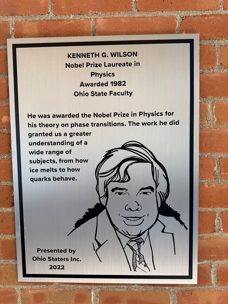 Kenneth Wilson's silver plaque on the wall of the 18th street library