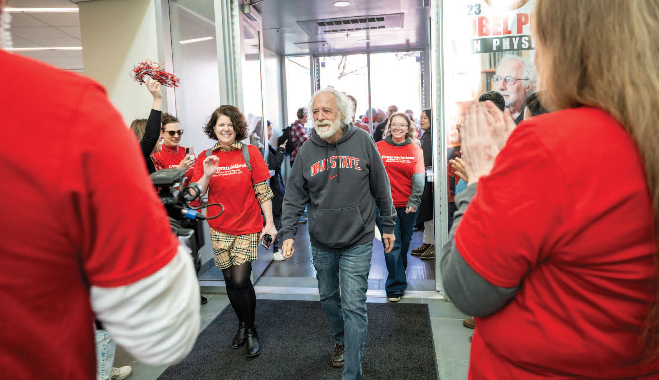 Over 300 Ohio State students, staff and faculty greet Professor Agostini at the entrance to the Physics Research Building at a clap-in event on March 20, 2024.