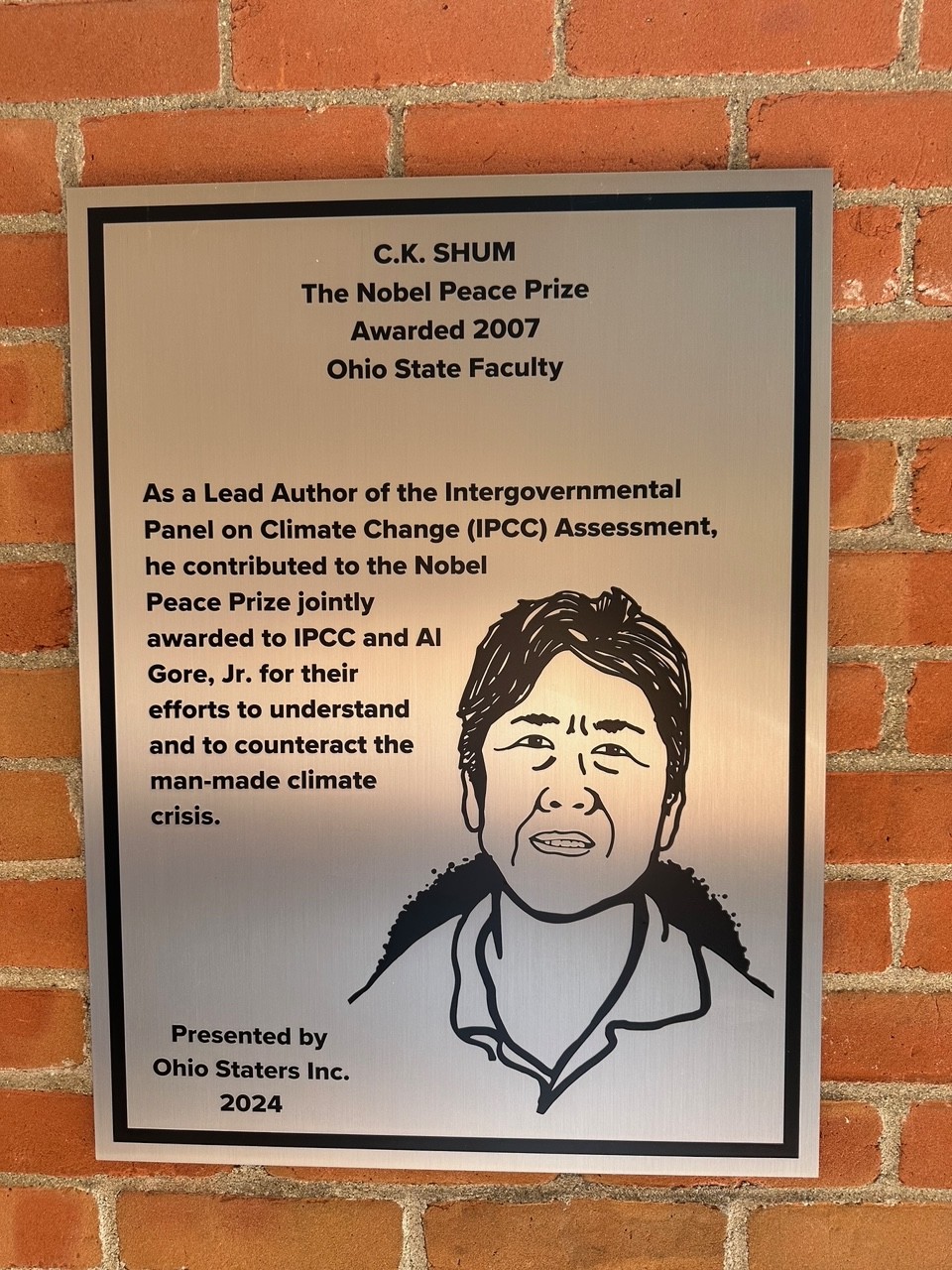 C.K. Shum's silver plaque on the wall of the 18th street library