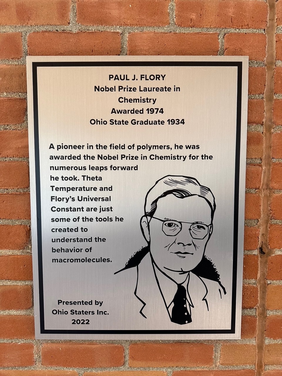 Paul Flory's silver plaque on the wall of the 18th street library