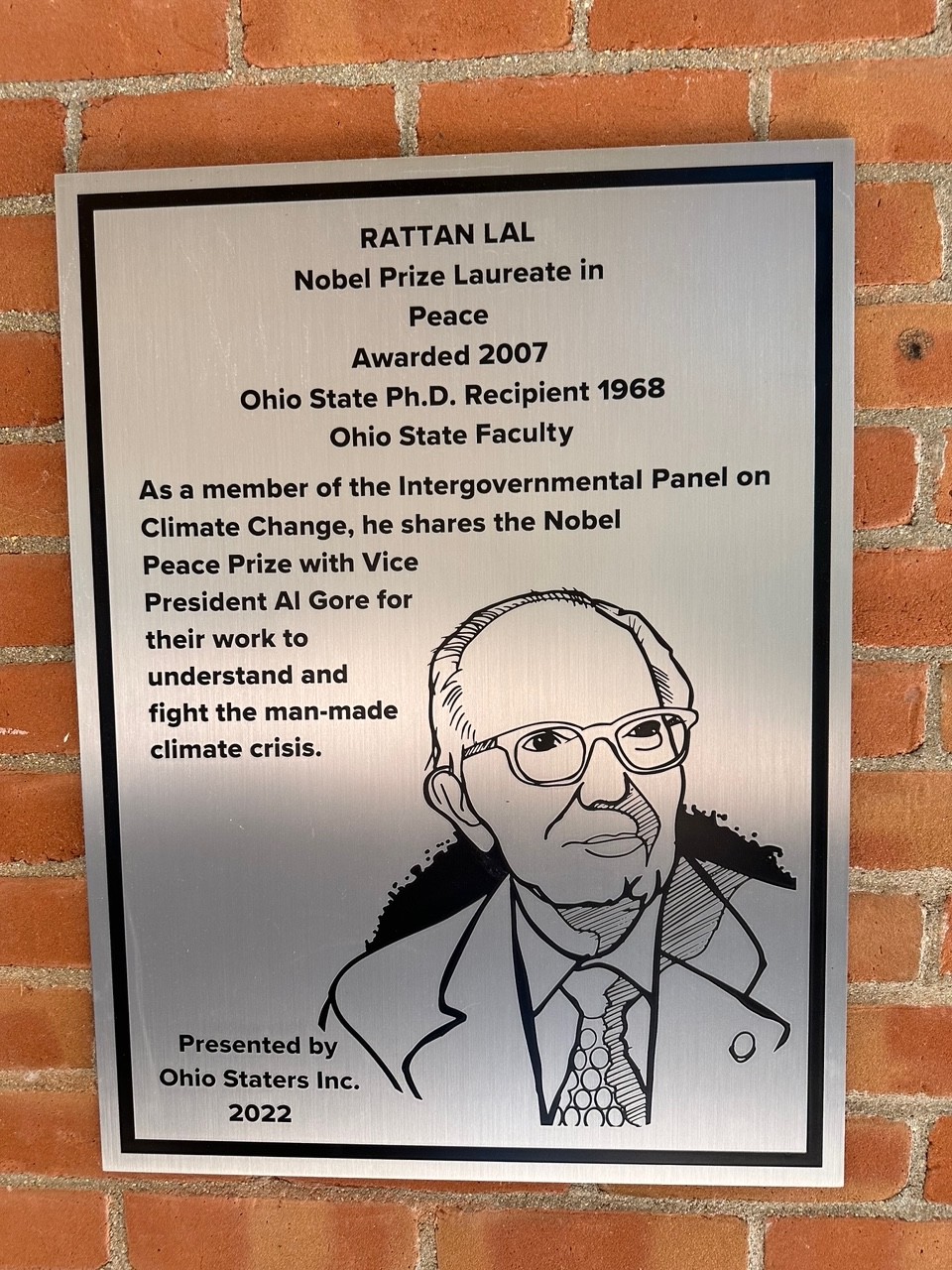 Rattan Lal's silver plaque on the wall of the 18th street library