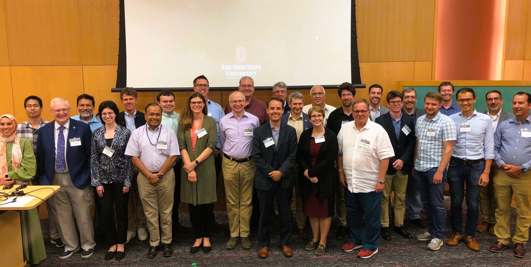 The picture shows a group photo of participants at the workshop.