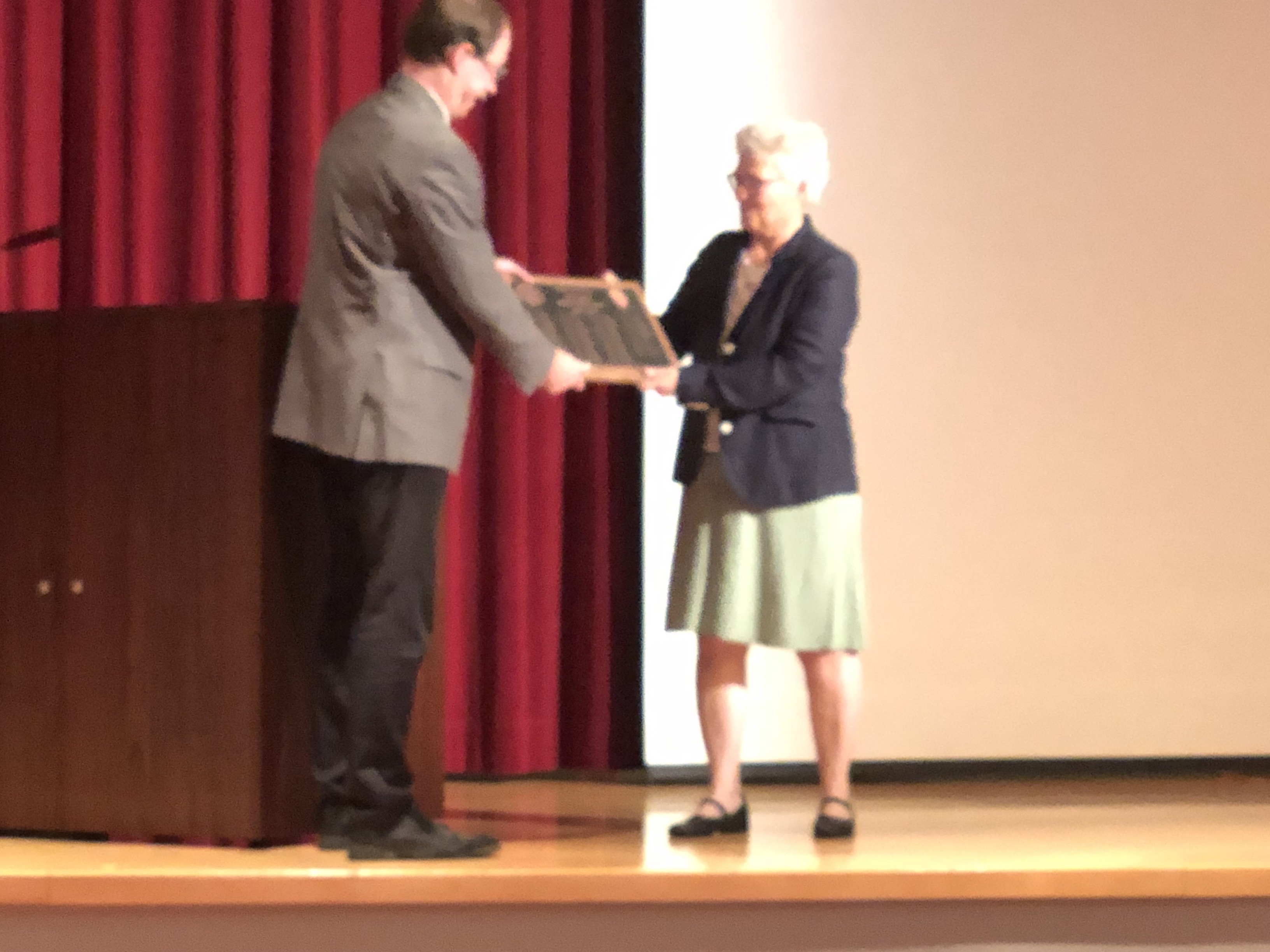 Chair Ralf Bundschuh presenting Dr. L'Huillier with a plaque