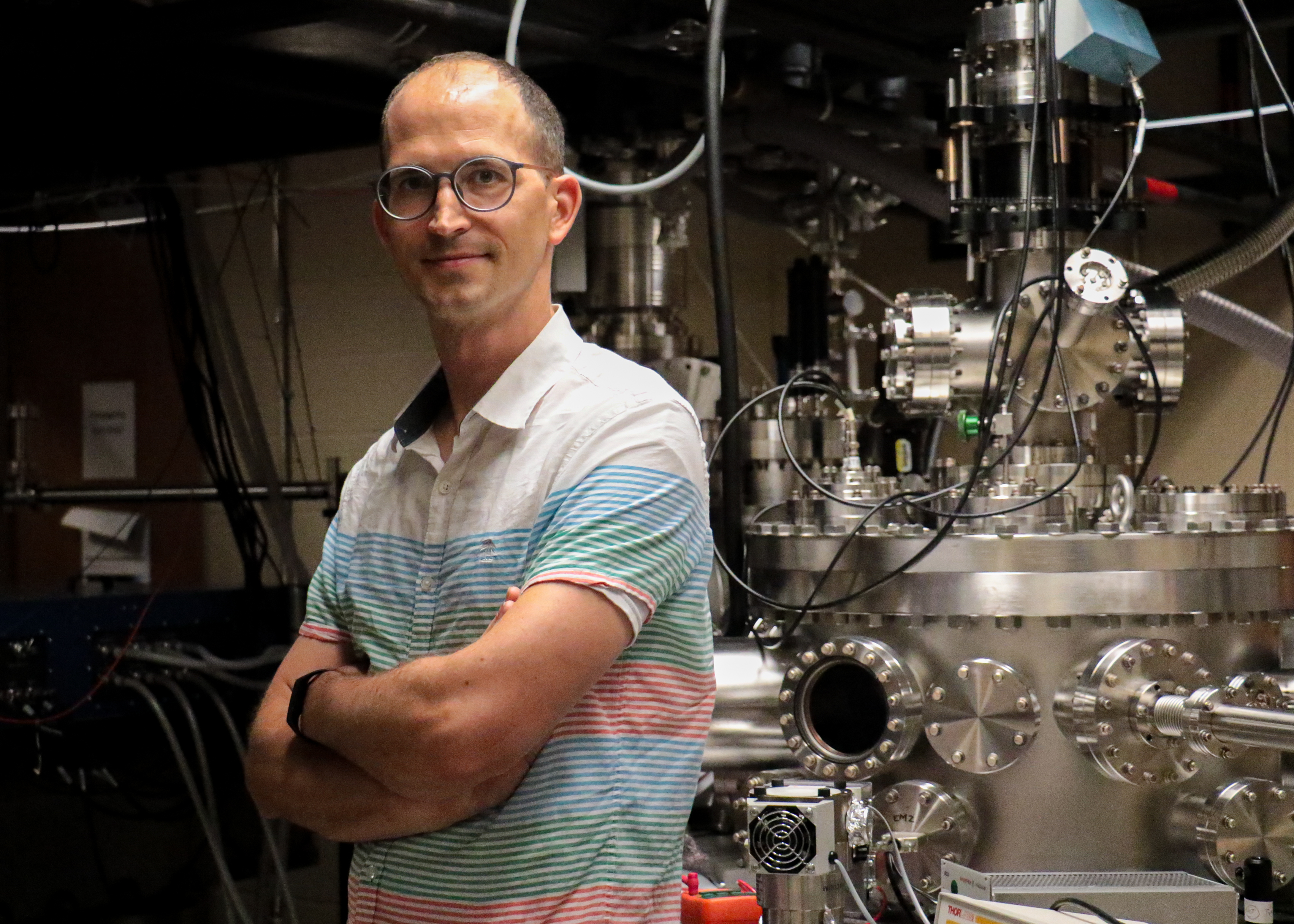 Michael Chini standing with arms crossed in the lab