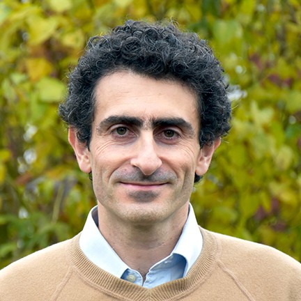 Guido Festuccia smiling in front of trees