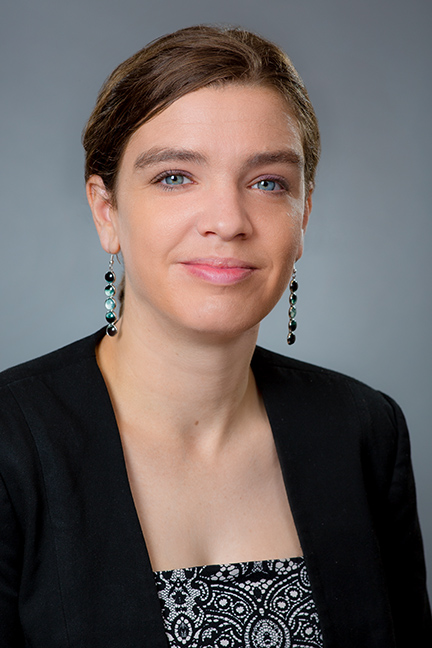 Therese Jones smiling with a grey background