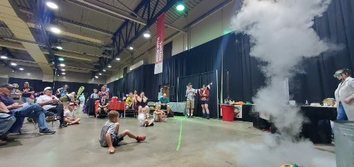 Kids and fair attendees looking on at an experiment