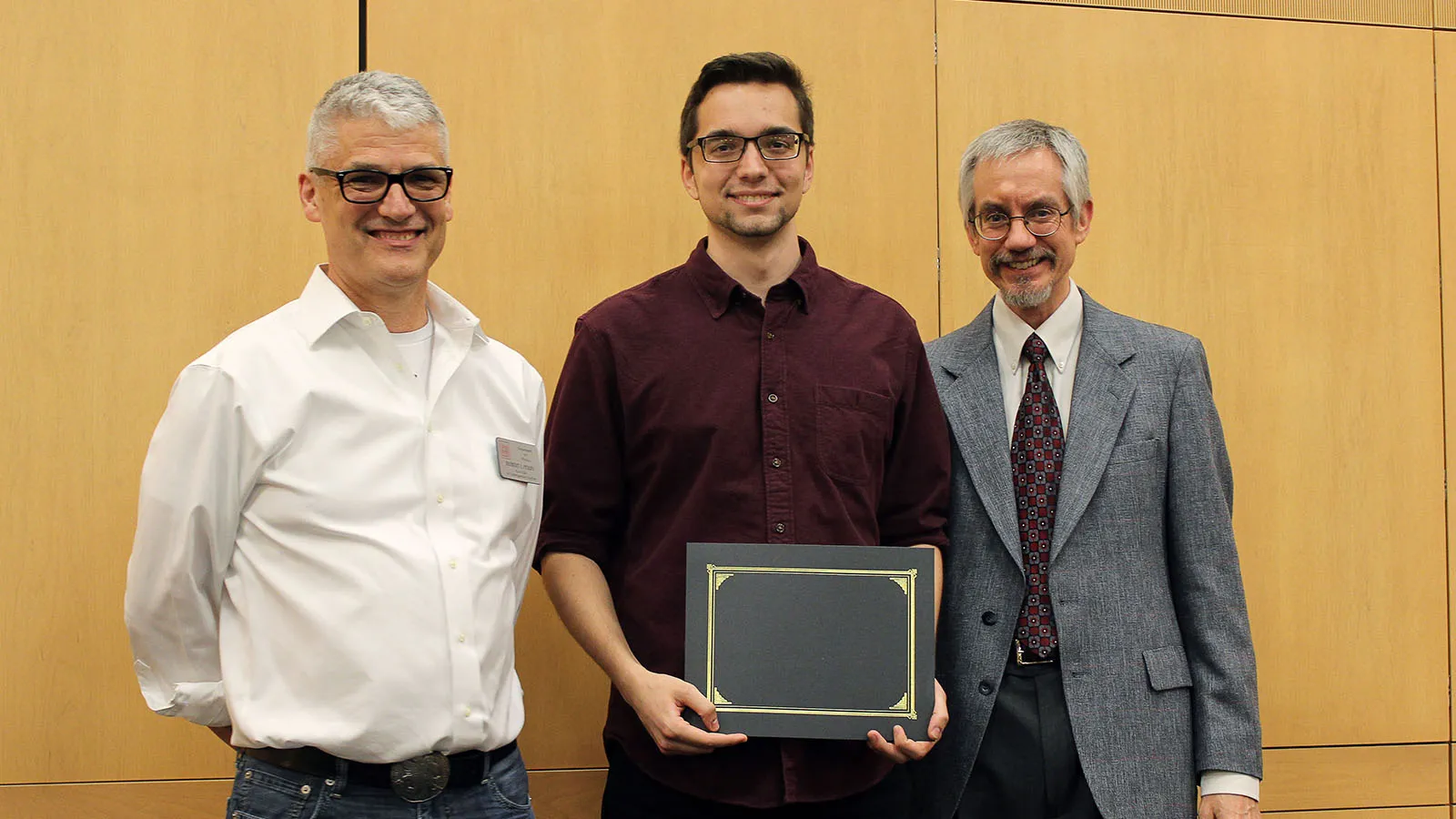 Student with faculty at awards ceremony