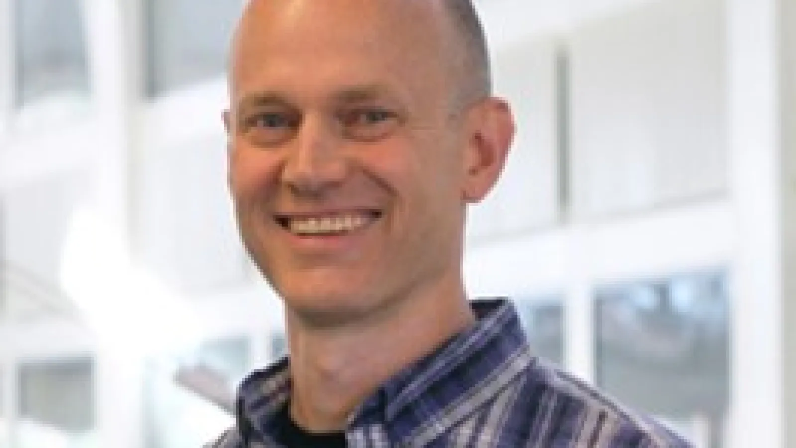 John Beacom smiling with PRB Atrium in the background