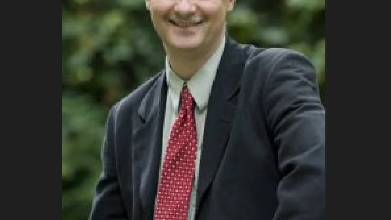 Dr. Eric Borguet, a white man wearing a red tie.