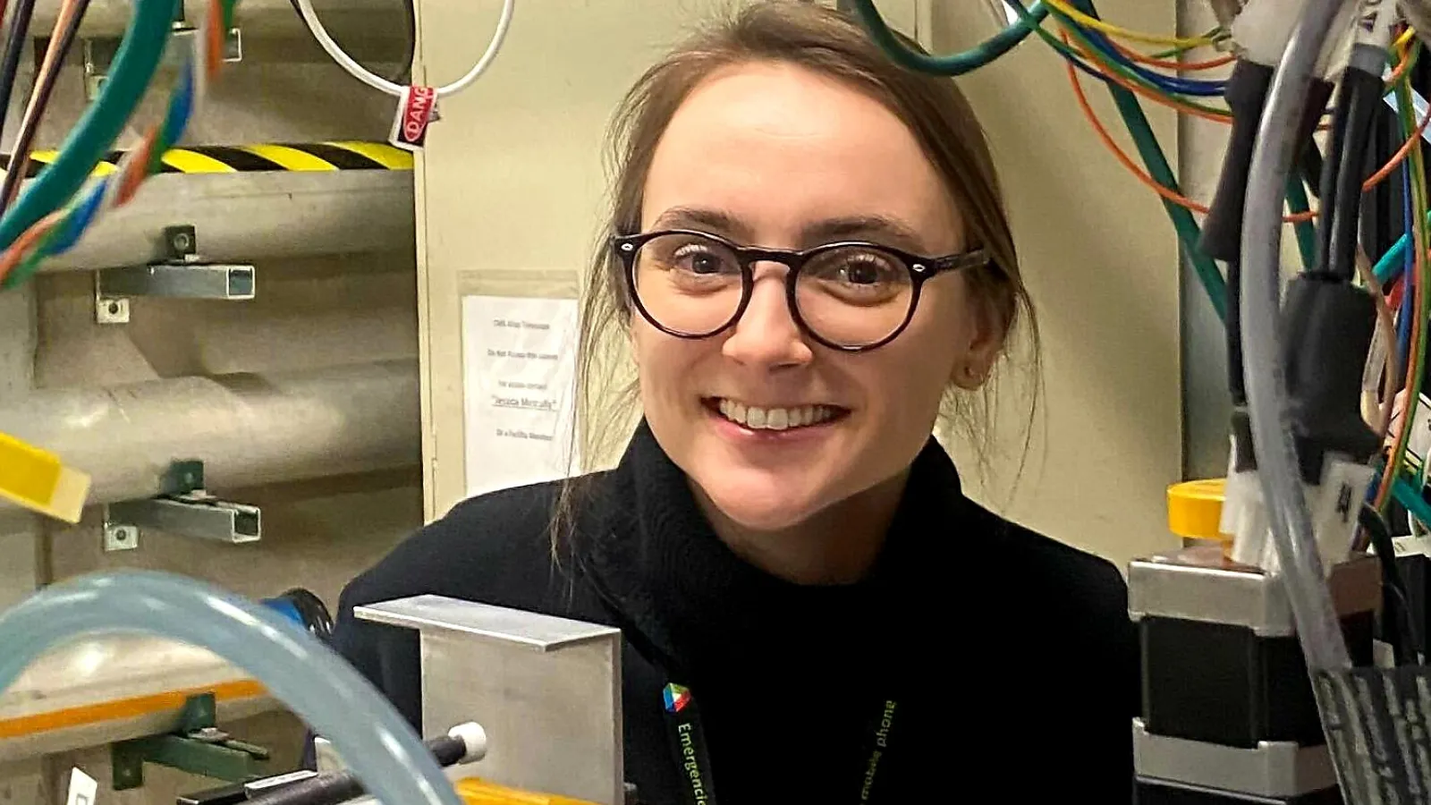 Maria Zurek in her lab, surrounded by wires and equipment