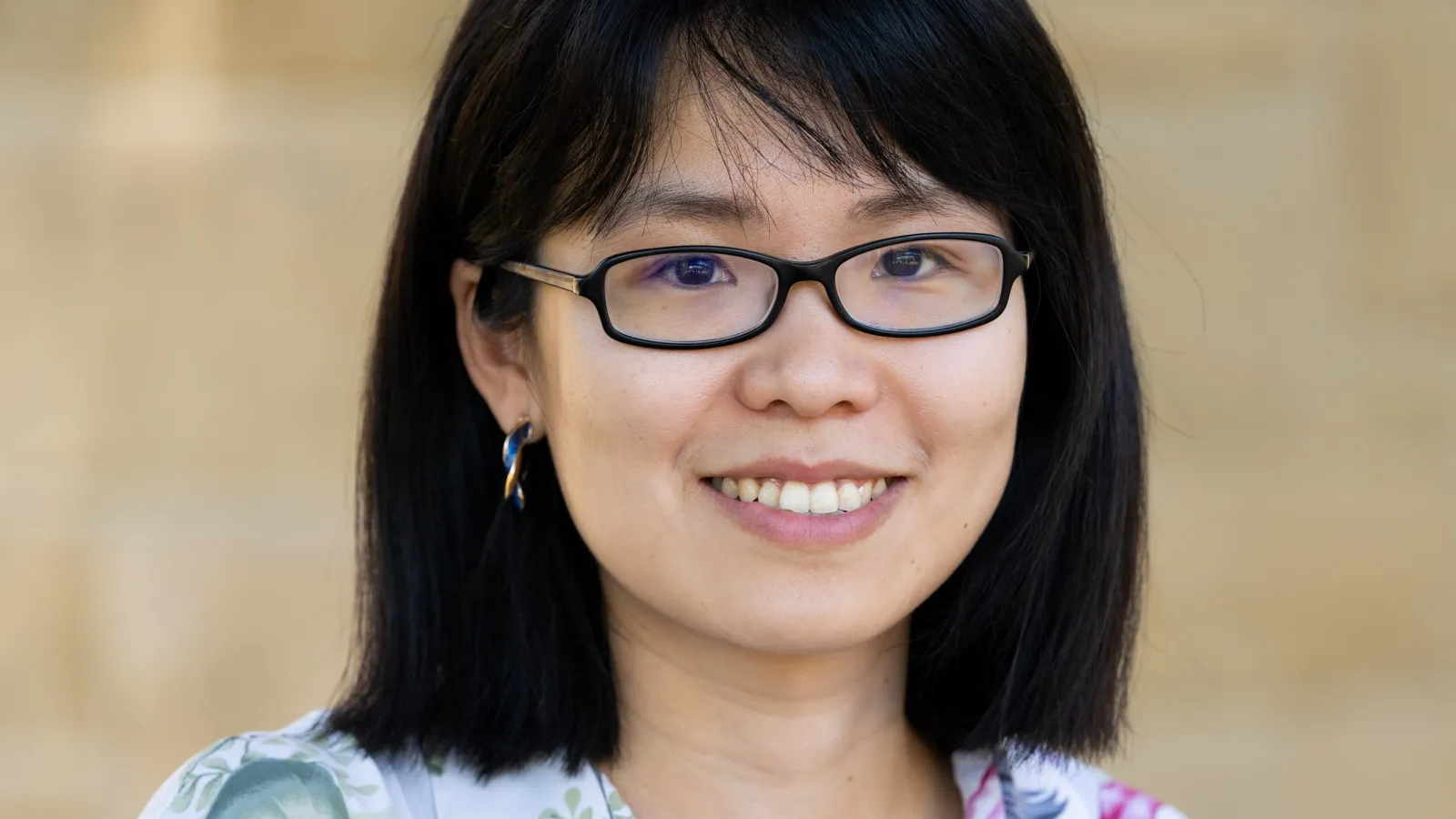 Linda Ye headshot with beige background