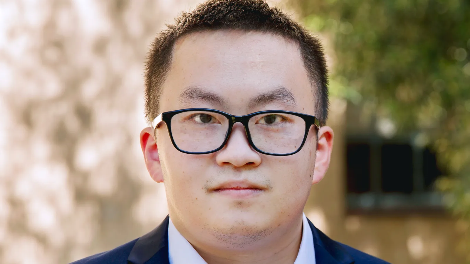 Junyu Liu with trees in the background
