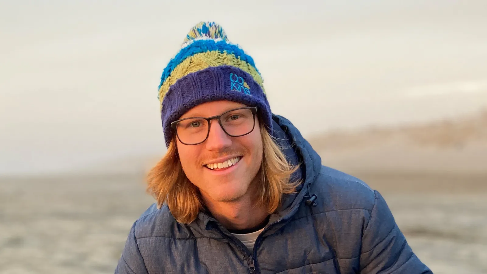Scott Haselschwardt on the beach with his dog
