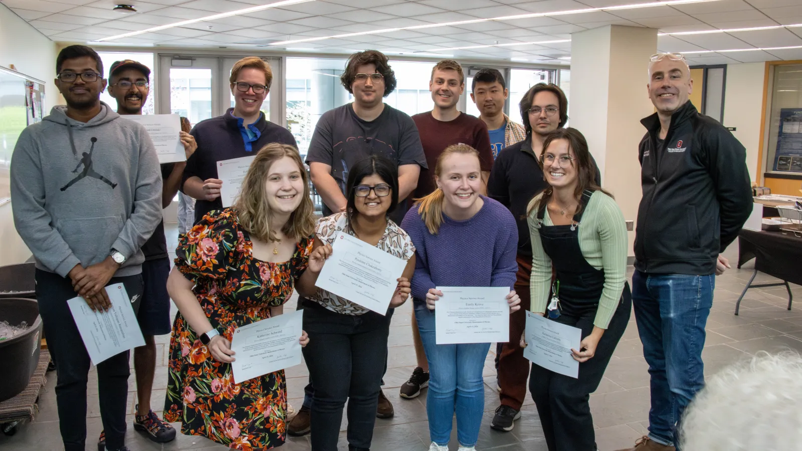 The grad student award winners holding their certificates