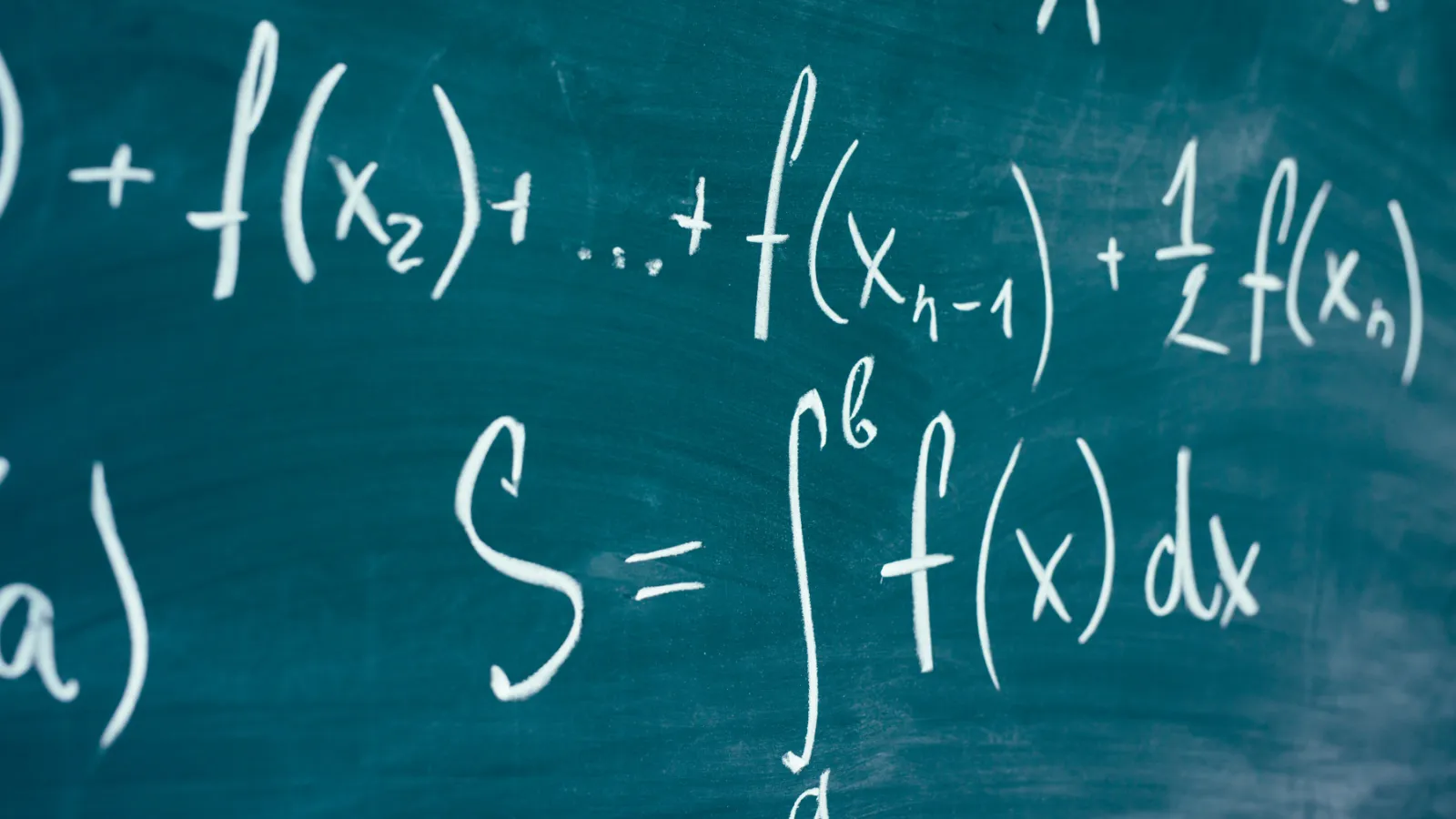 Various equations written on a chalkboard