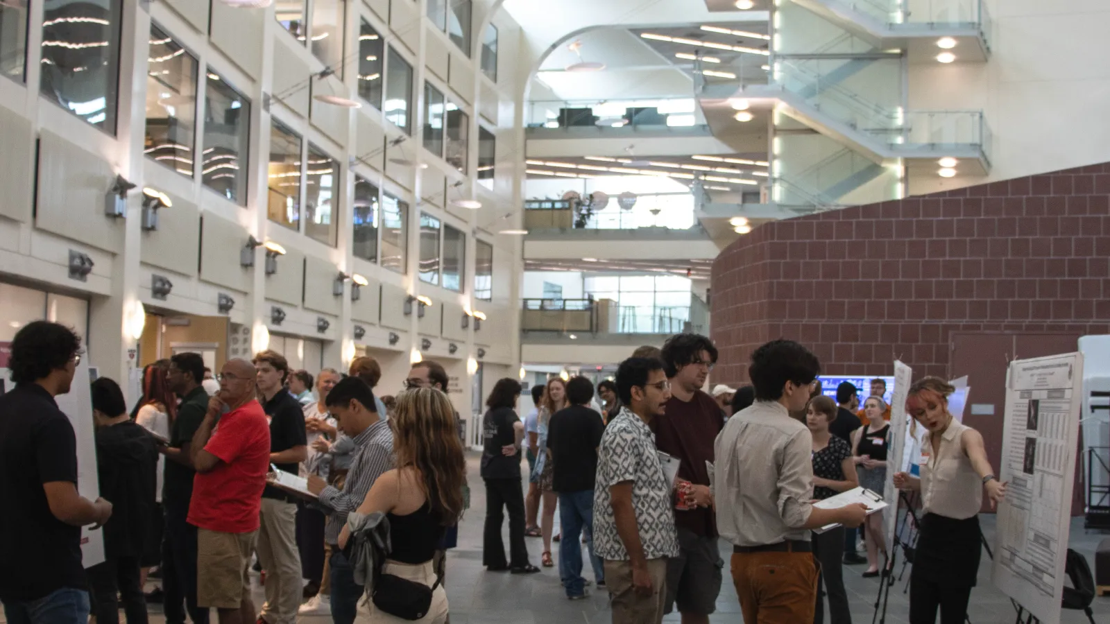 Crowd of students and faculty in the PRB Atrium for a poster session
