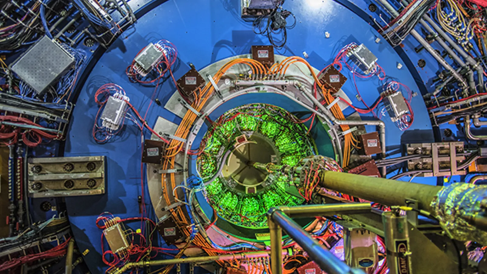 Nuclei traveling at 99.955% the speed of light travel down the vacuum tube entering the STAR experiment. They collide at the center of the massive detector, producing thousands of particles that physicists analyze offline. Photo courtesy of: Brookhaven National Laboratory, CC BY-NC-ND 2.0, flickr.com/photos/brookhavenlab