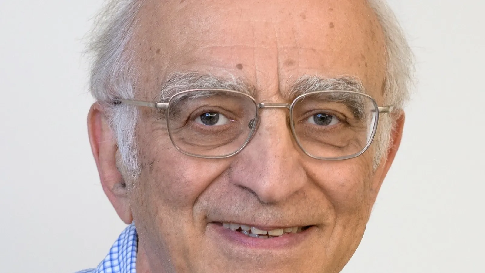 Boris Shklovskii smiling with white background