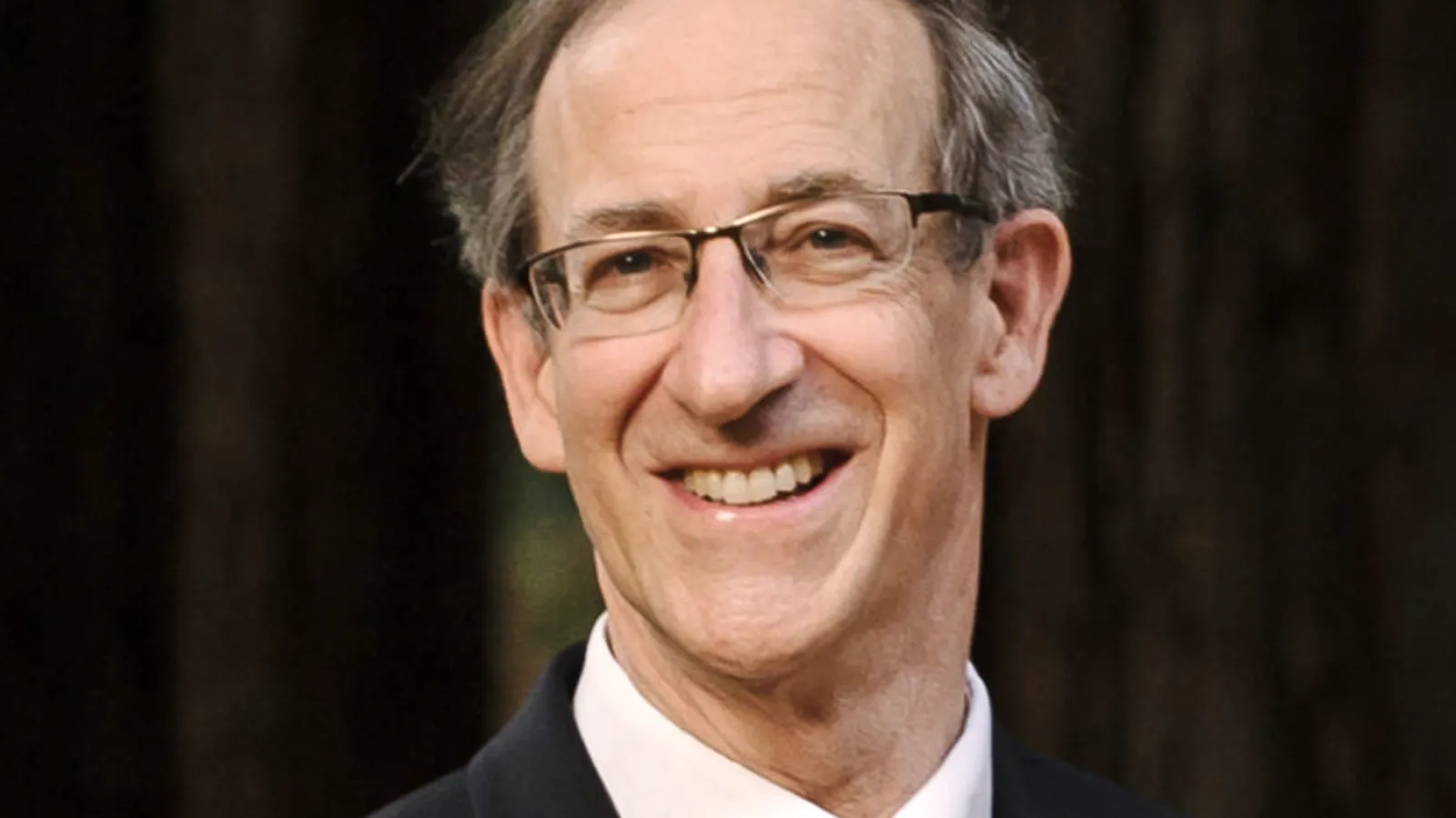 Tony Heinz smiling with trees behind him