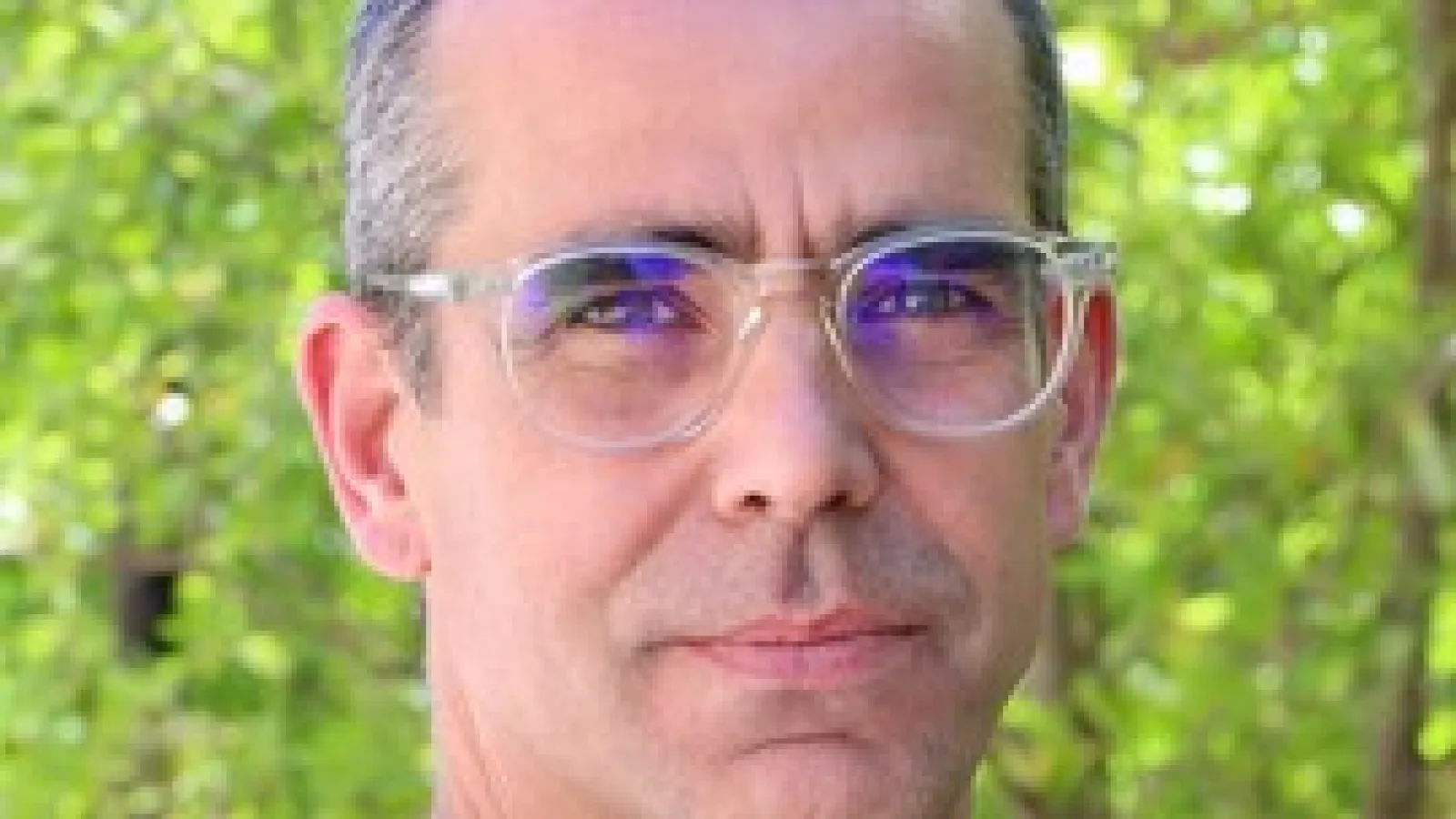 Eric Brewe in front of a line of trees