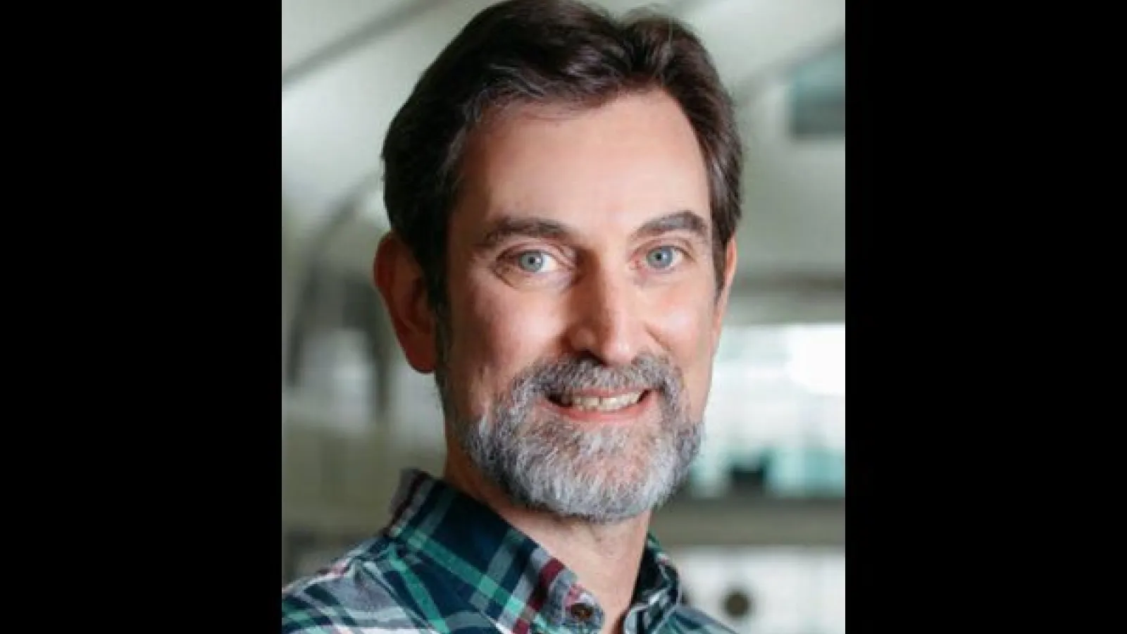 Professor Furnstahl smiling with the PRB in the background
