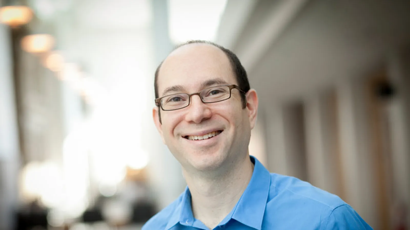 Jeff Moses smiling with blurred background