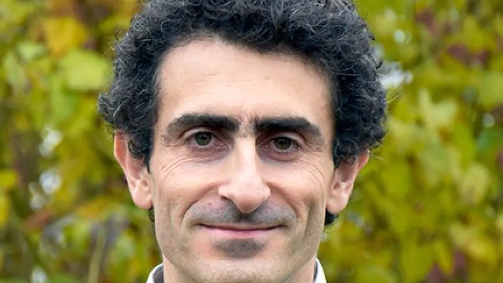 Guido Festuccia smiling in front of trees
