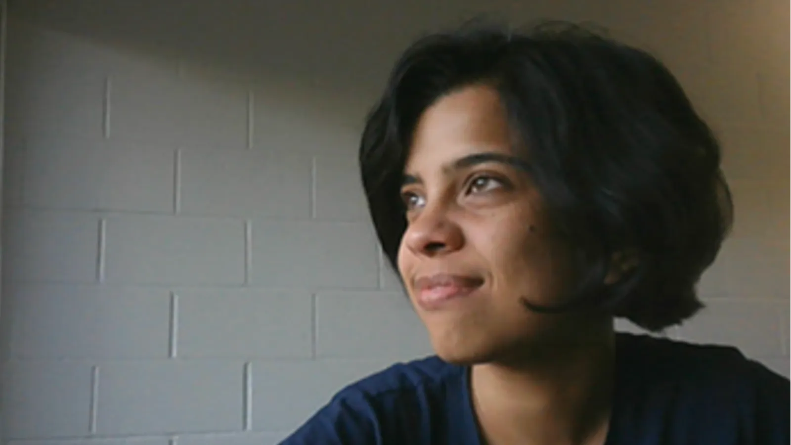 Srimoyee Sen smiling and looking off into the distance