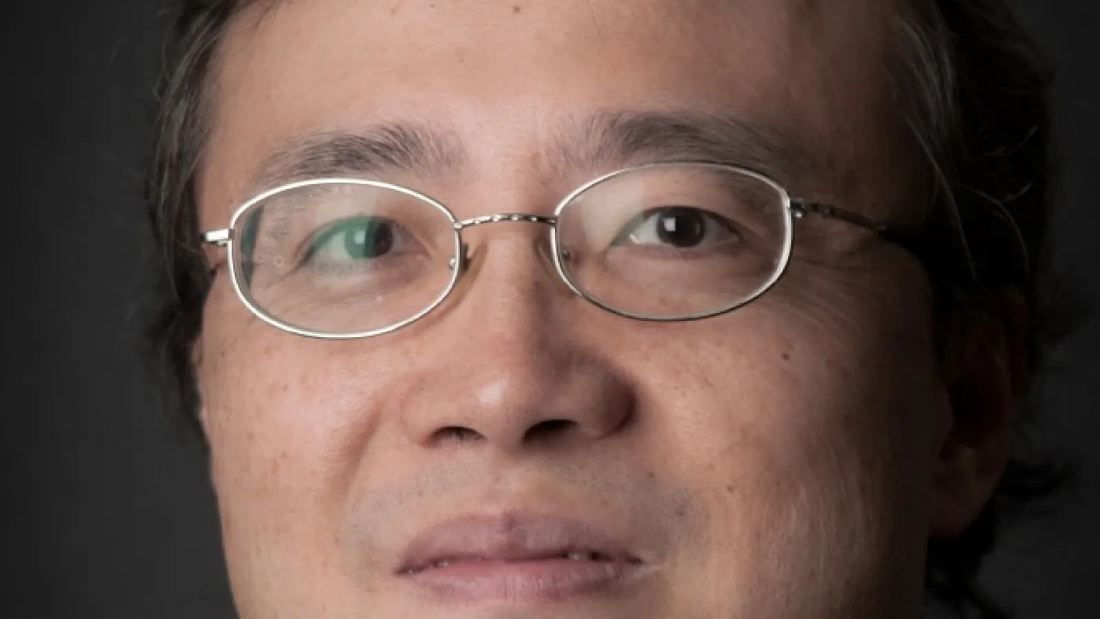 Kun Yang with plain black background