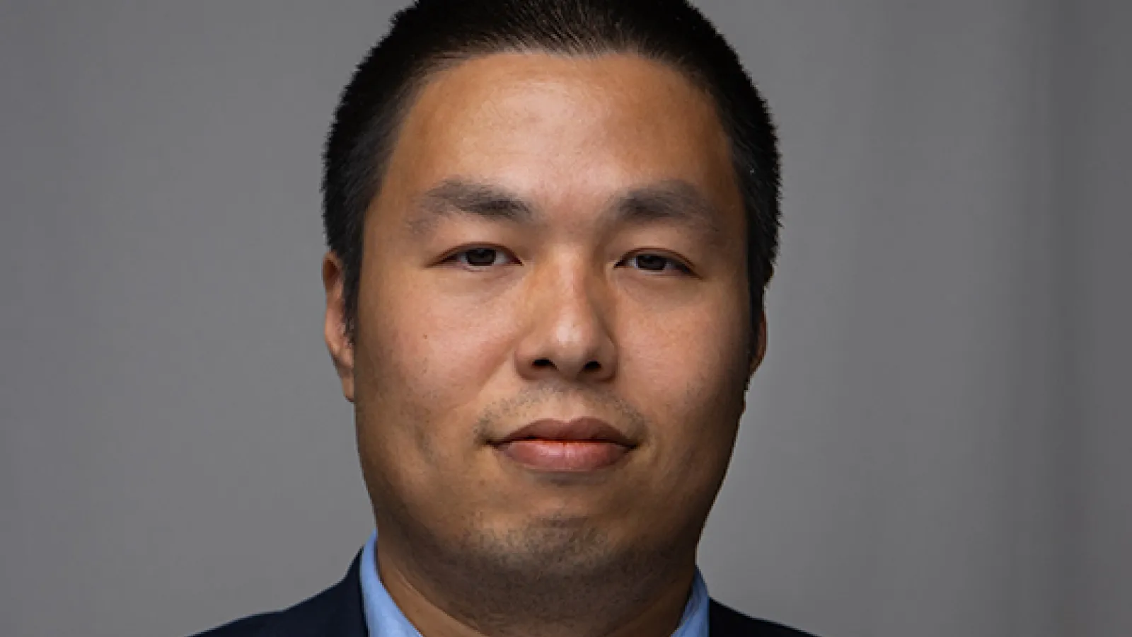 Shenglong Xu headshot with grey background