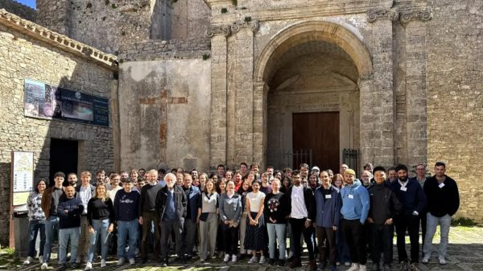 IOS international group members in front of a large stone gate