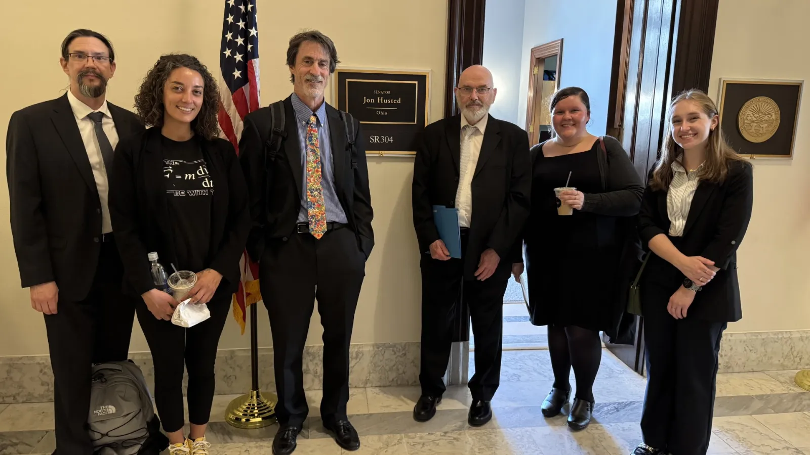 Professor Mike Lisa and student Josie Rose standing in front of senator's office