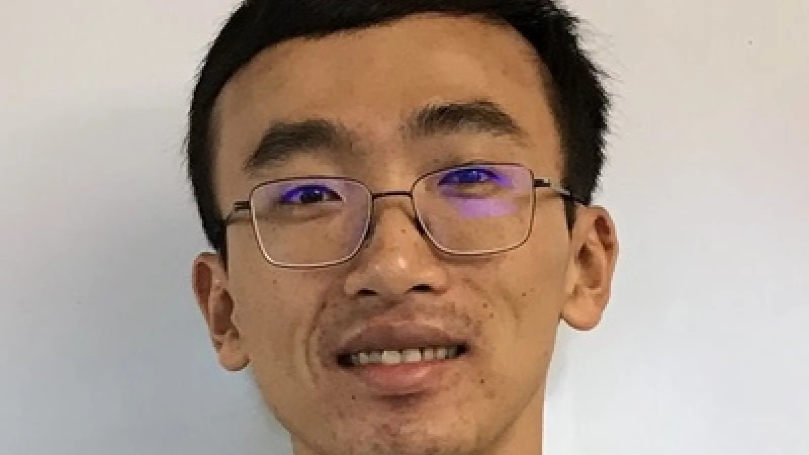 Jung-Tsung's close up with plain white wall behind him