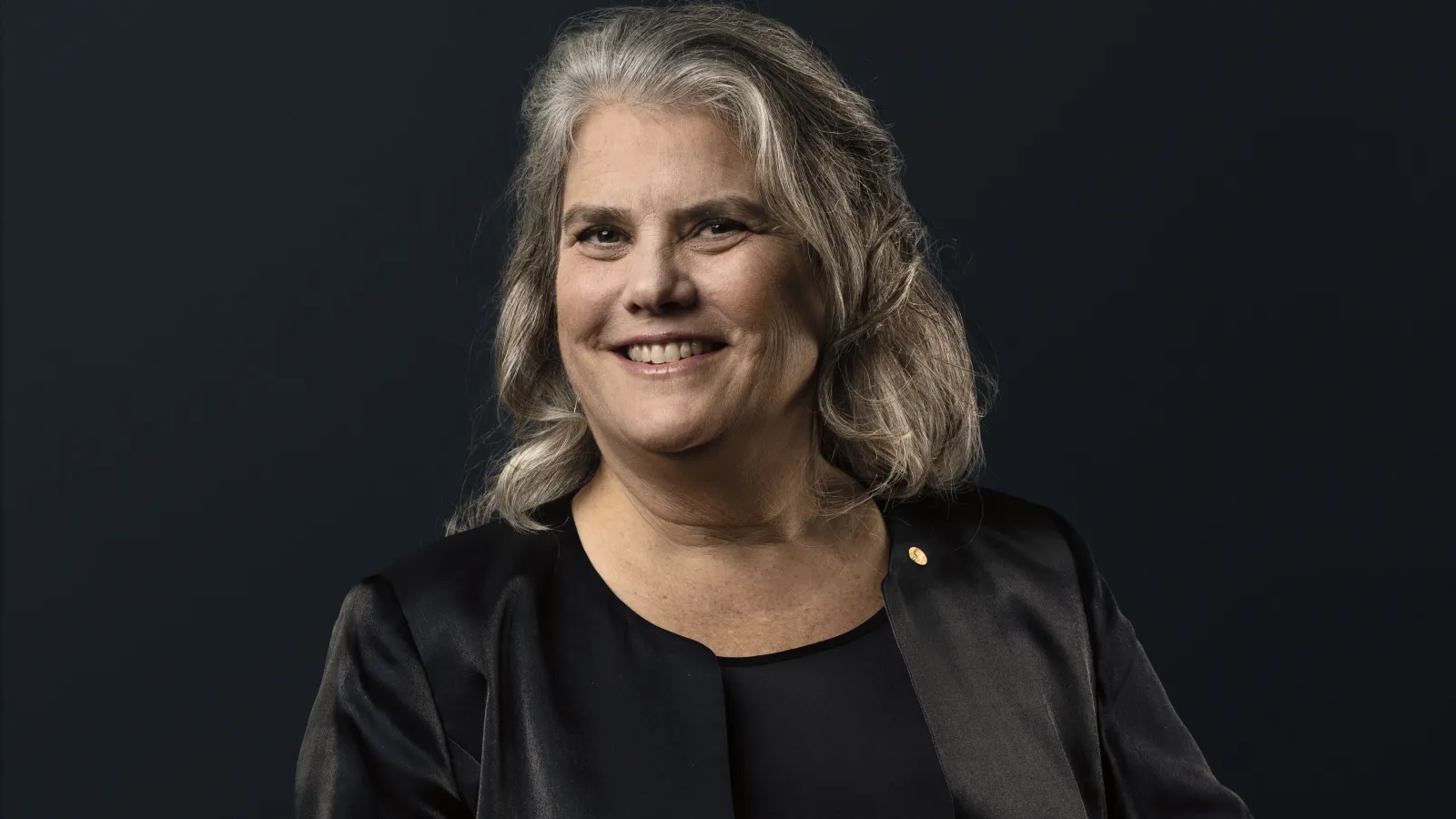 Andrea Ghez in front of a black backdrop