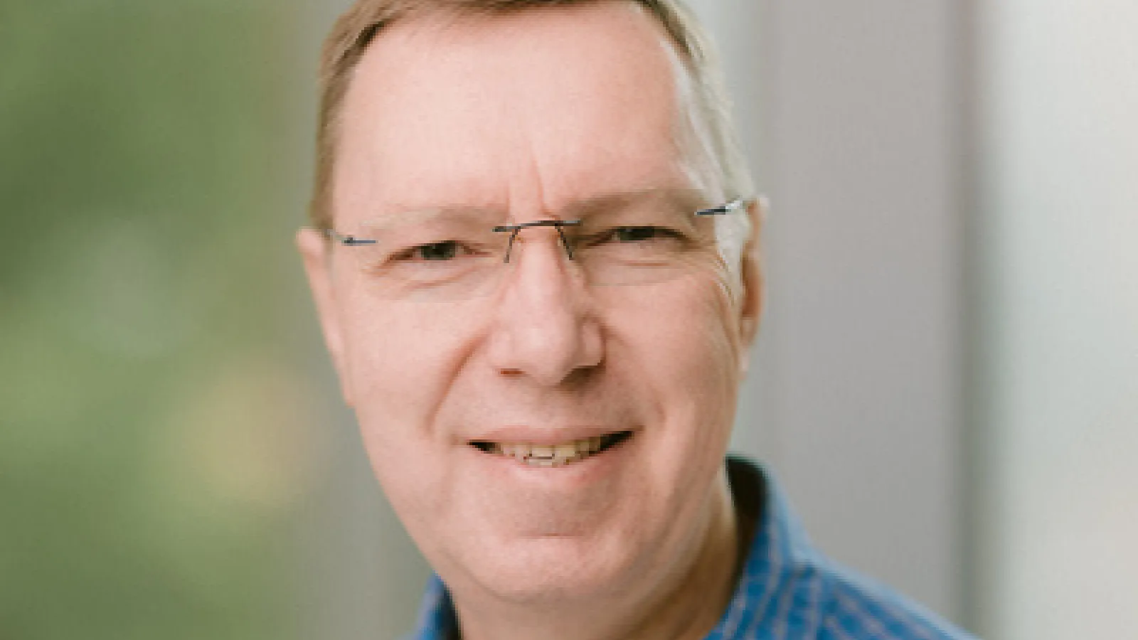 Close up of Professor Gruzberg in front of a window