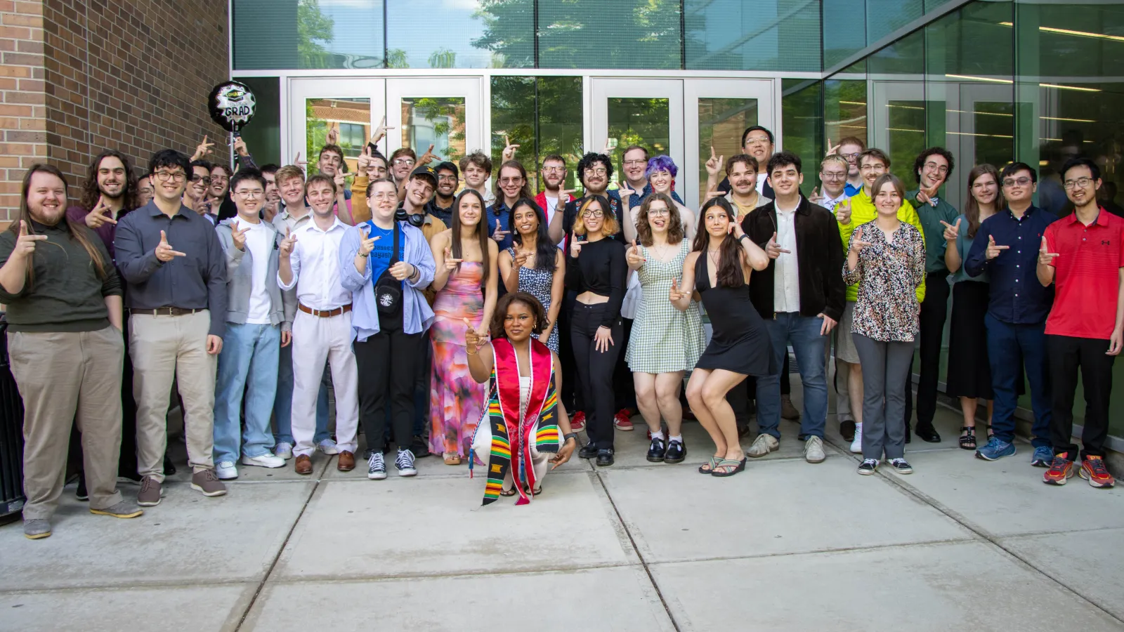 Group Photo of 2025-2026 graduates doing the "right hand rule"