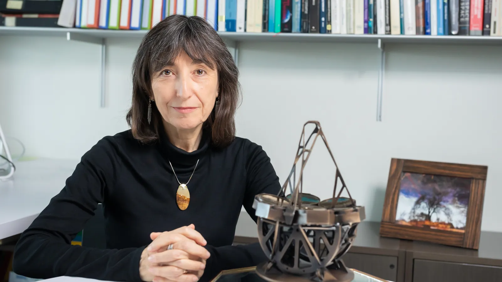 Wendy Freedman sitting at a white table with her hands folded