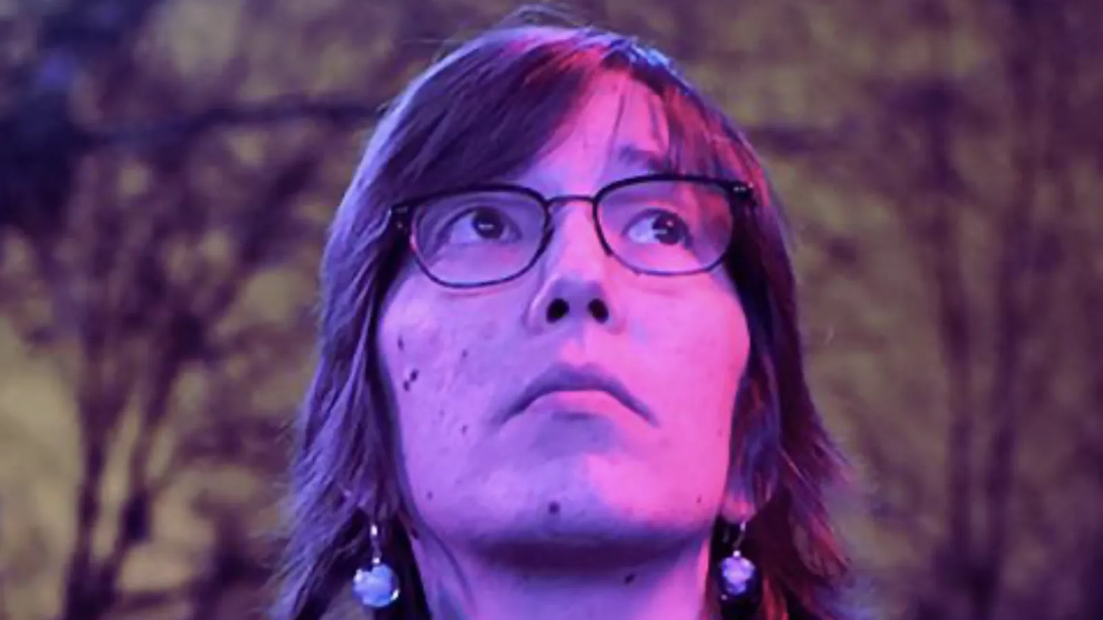 mia professional headshot with purple lighting