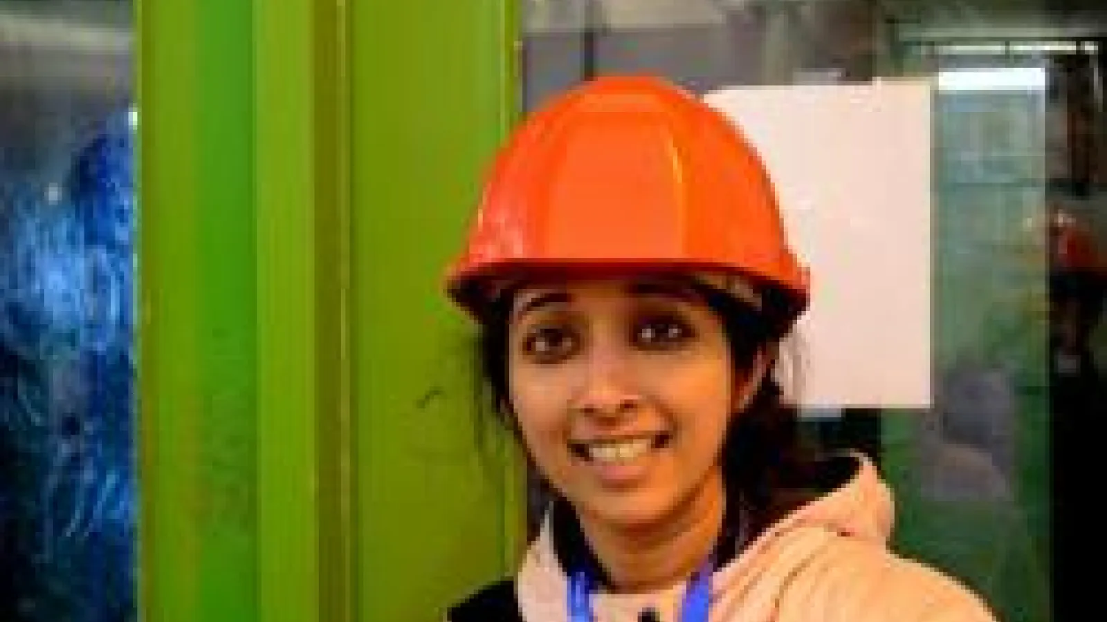 Archana Anandakrishnan smiling in orange hard hat