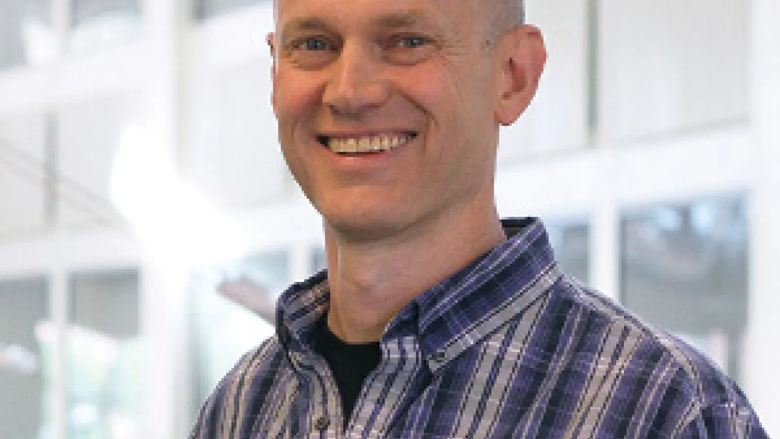 John Beacom smiling with PRB Atrium in the background