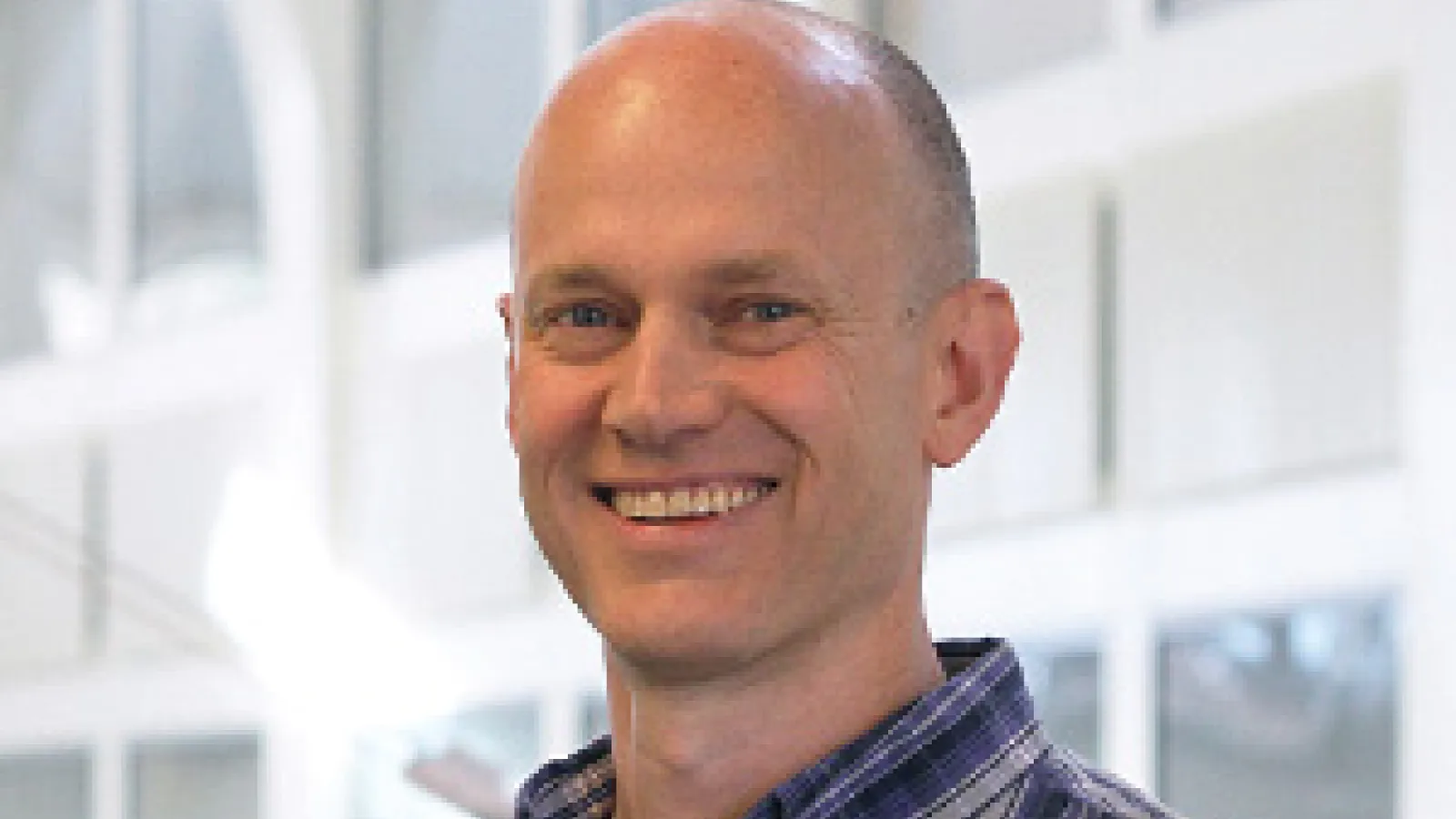 John Beacom smiling with PRB Atrium in the background