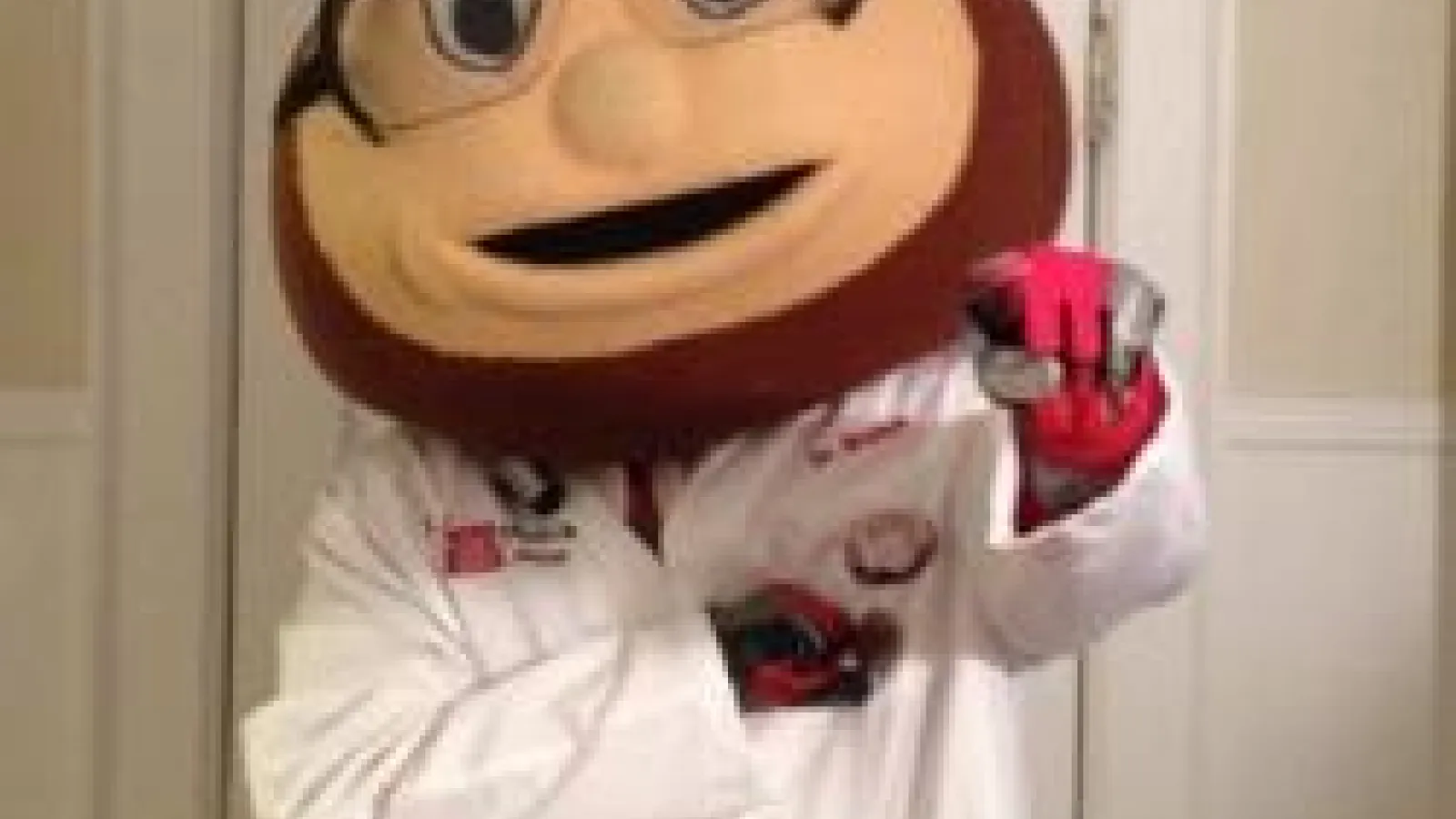 Brutus Buckeye wearing PPE: goggles, lab coat, and gloves.