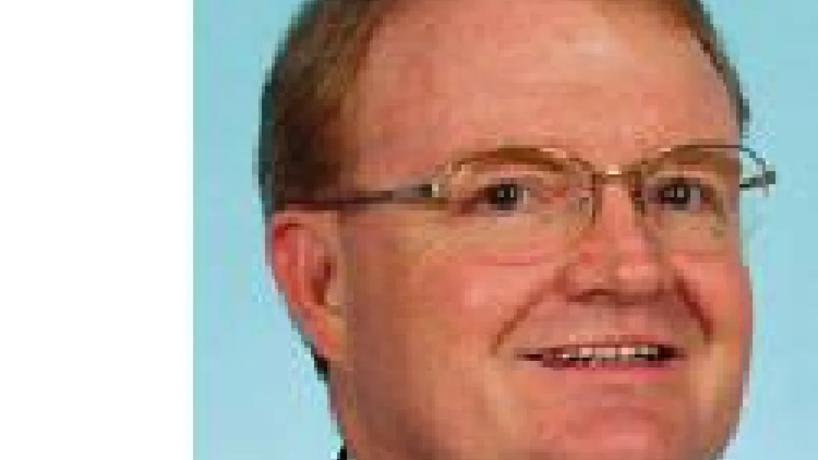 John Corrigan with light blue background