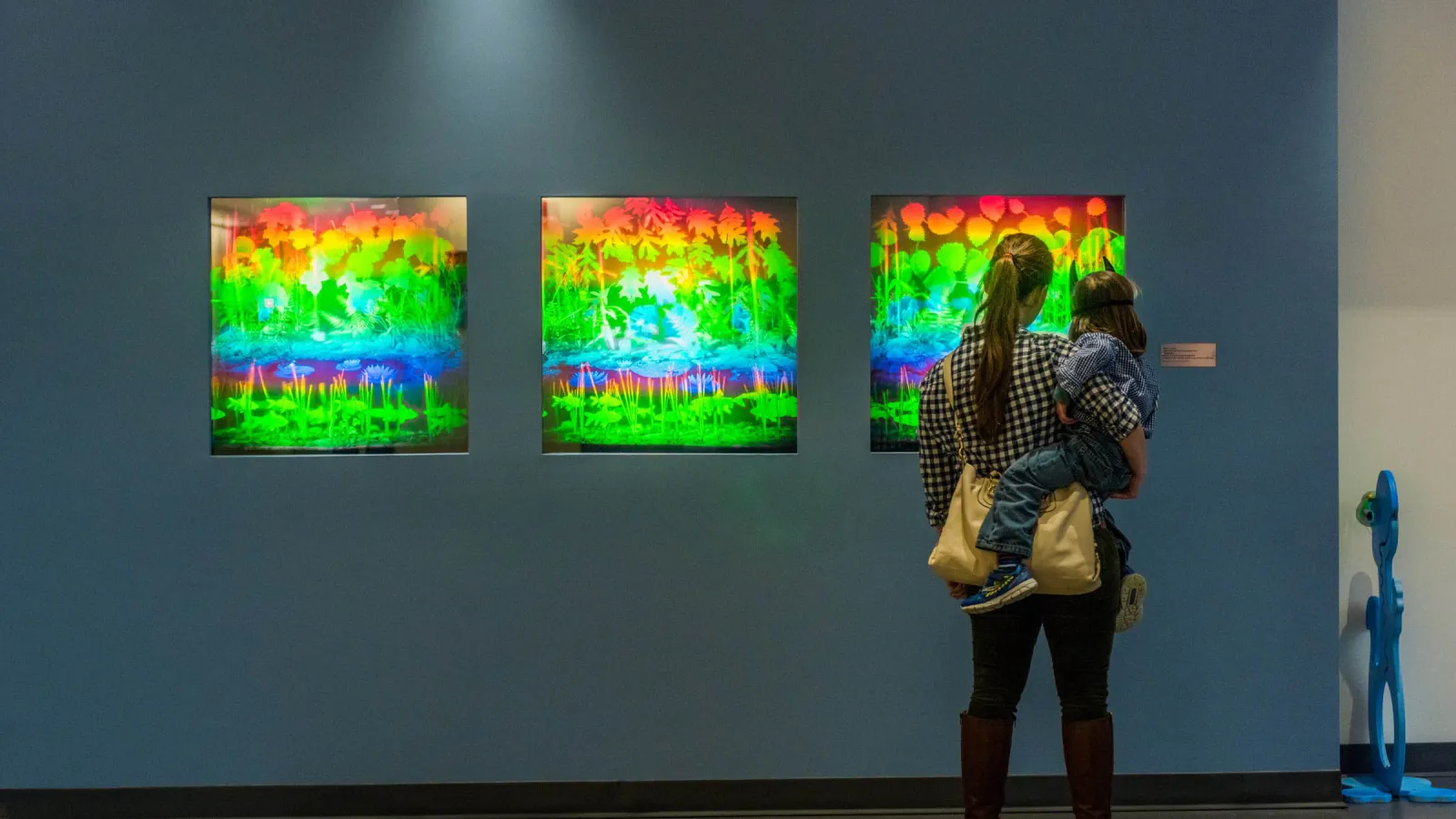 Woman looking at holograms by Betsy Connors