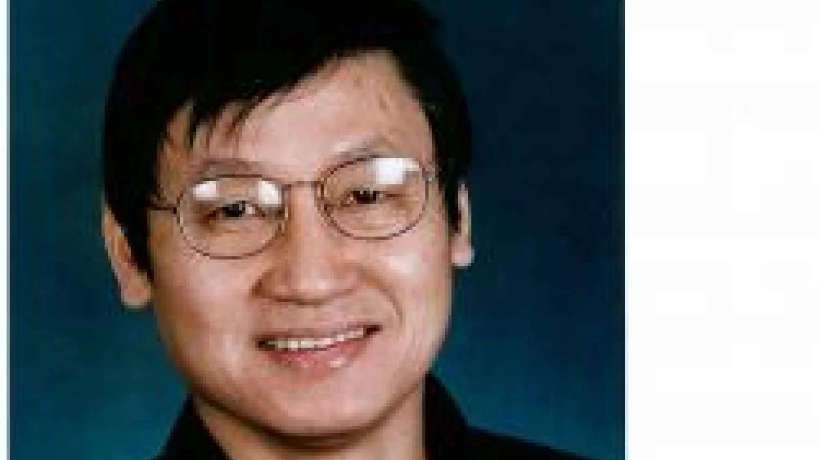 Jason Ho smiling with blue background
