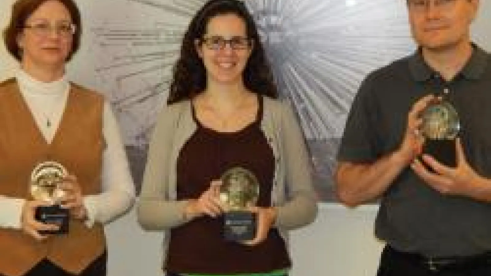The staff holding their awards. On the left is Kris Dunlap with Lisa Colarosa in the middle and Eric Robbins on the right.